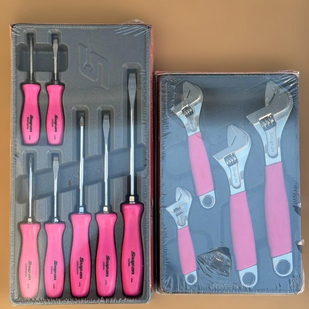 Shrink-wrapped trays showing pink-handled Snap-on screwdrivers and pink-handled adjustable wrenches.