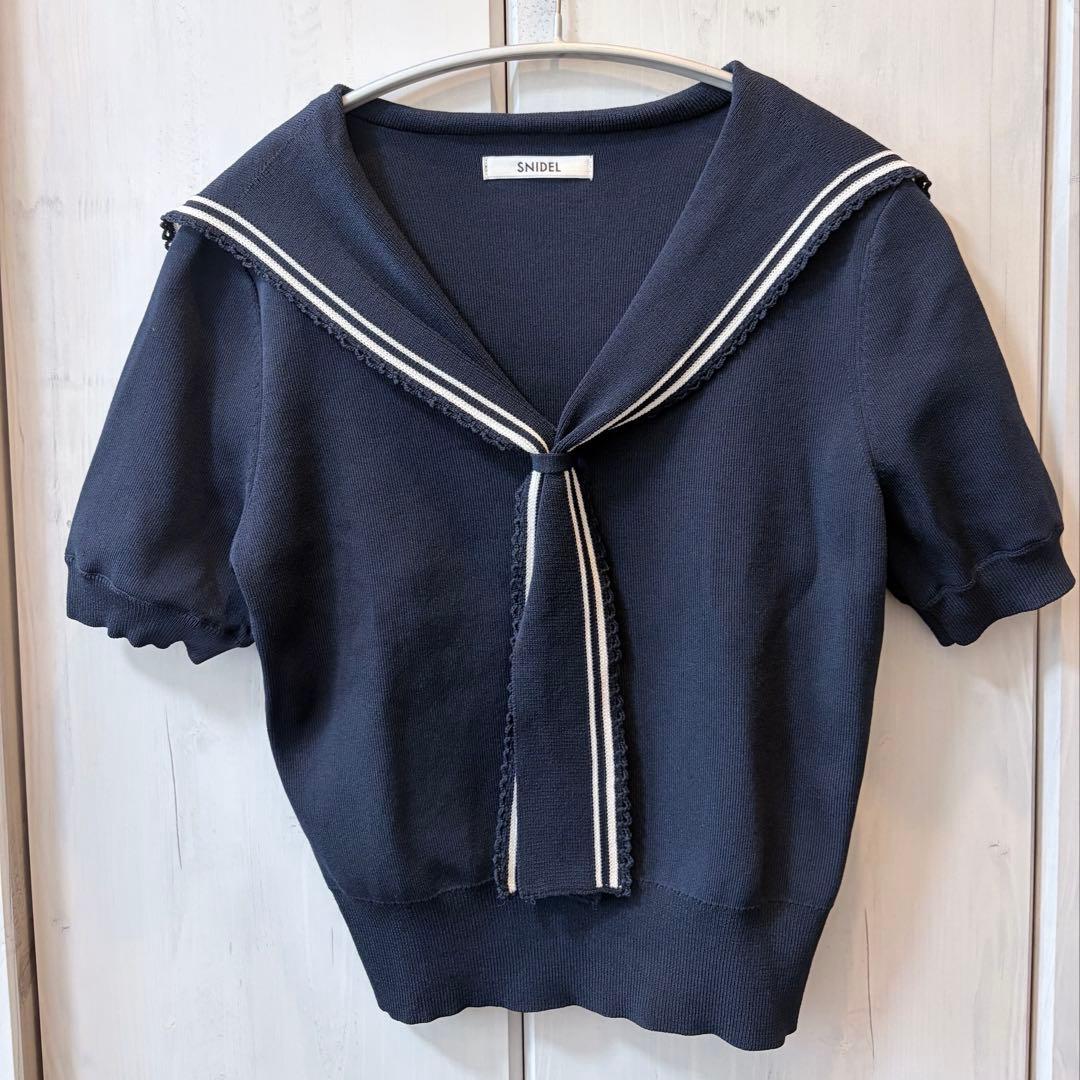 Front view of a navy SNIDEL sailor-collar knit pullover (women's shirt) hanging on a hanger.