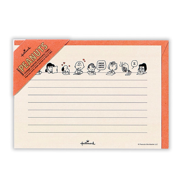 Top view of a Snoopy letter sheet with an orange border, horizontal writing lines, and Peanuts characters illustrated along the top.