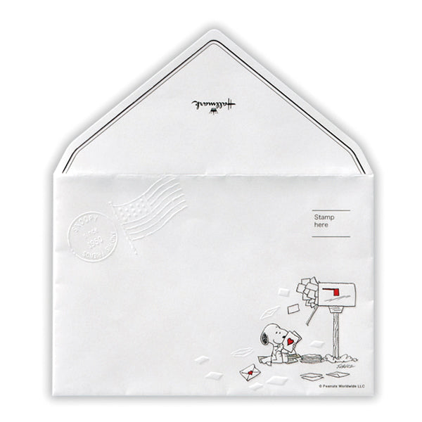 White letter-pad envelope decorated with a Snoopy illustration by a mailbox and scattered letters.