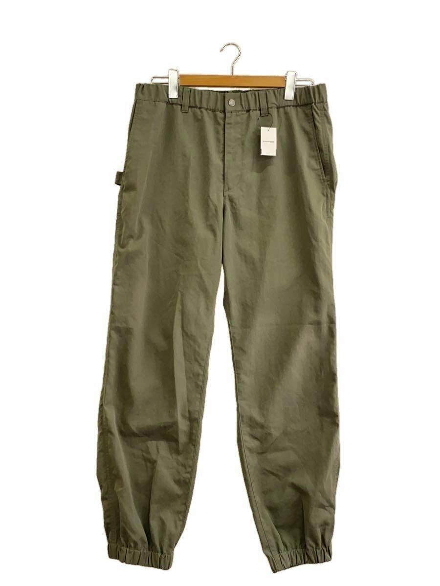 Front view of the men's cotton pants (snow peak) in gray hanging on a hanger, showing elasticized ankle cuffs and side pockets.