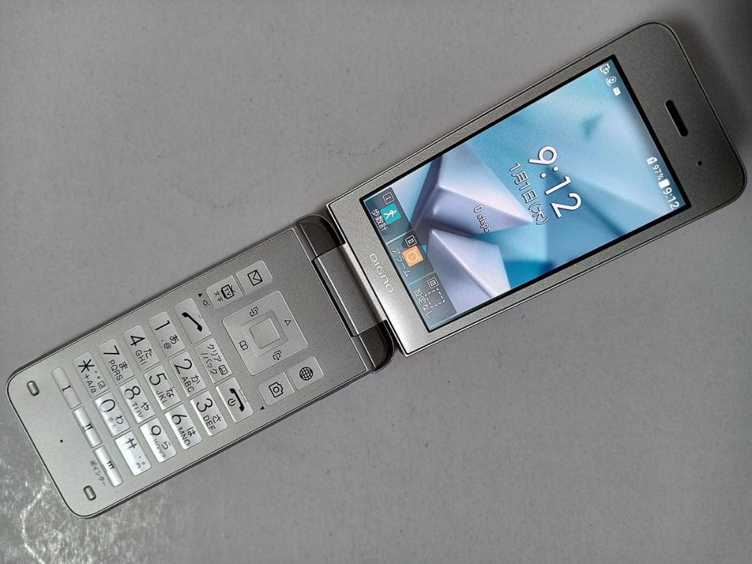 Silver SoftBank DIGNO 902KC flip mobile phone open, showing the keypad and touchscreen display.