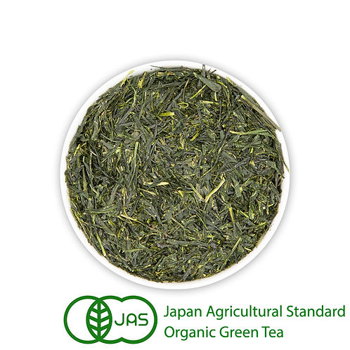 Top-down photo of loose-leaf green tea in a white bowl with a Japan Agricultural Standard organic logo.