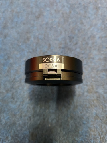 Close-up photo of a round black SOKKIA OF3A solar filter for a total station.