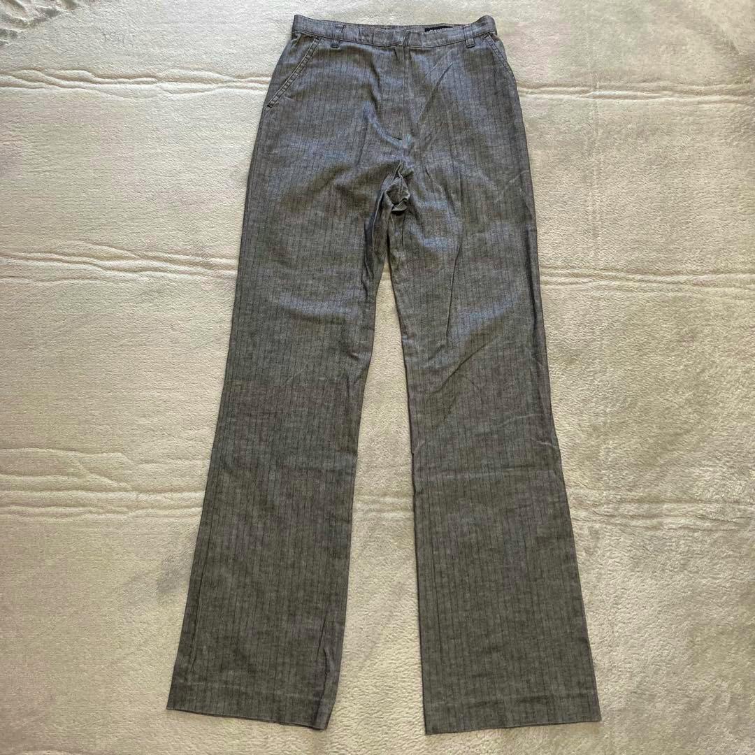 Gray men's long pants with a subtle vertical stripe pattern laid flat on a light surface.