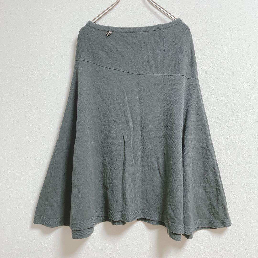 Grey SONIA RYKIEL knee-length wool-cashmere blend flared women's skirt hanging on a hanger against a white wall.