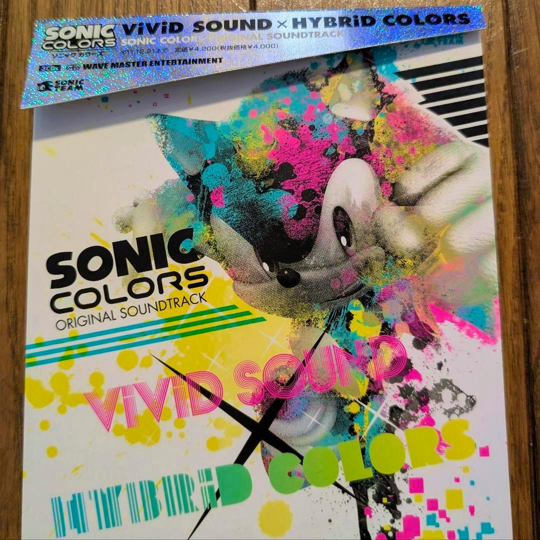 Front cover of the Sonic Colors ViViD SOUND×HYBRiD original soundtrack CD showing colorful spray‑paint style Sonic artwork and a holographic obi strip.