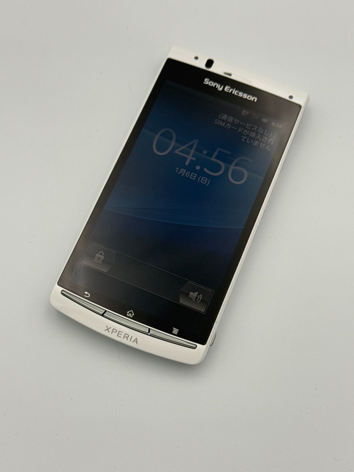Front view of a white Sony Ericsson Xperia acro IS11S smartphone on a light background.