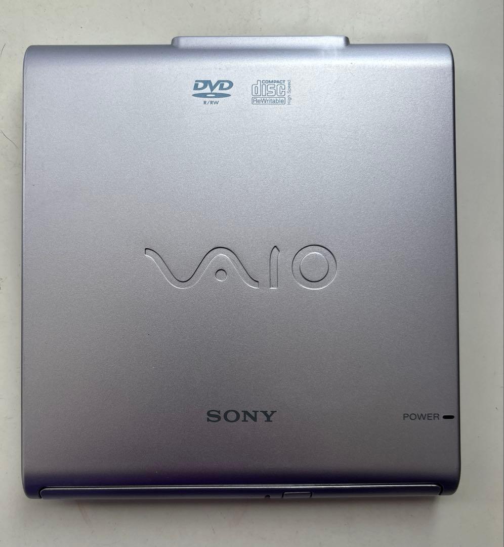 Top view of a silver Sony VAIO external CD-RW/DVD-ROM drive showing VAIO and Sony logos and DVD/Compact Disc markings.