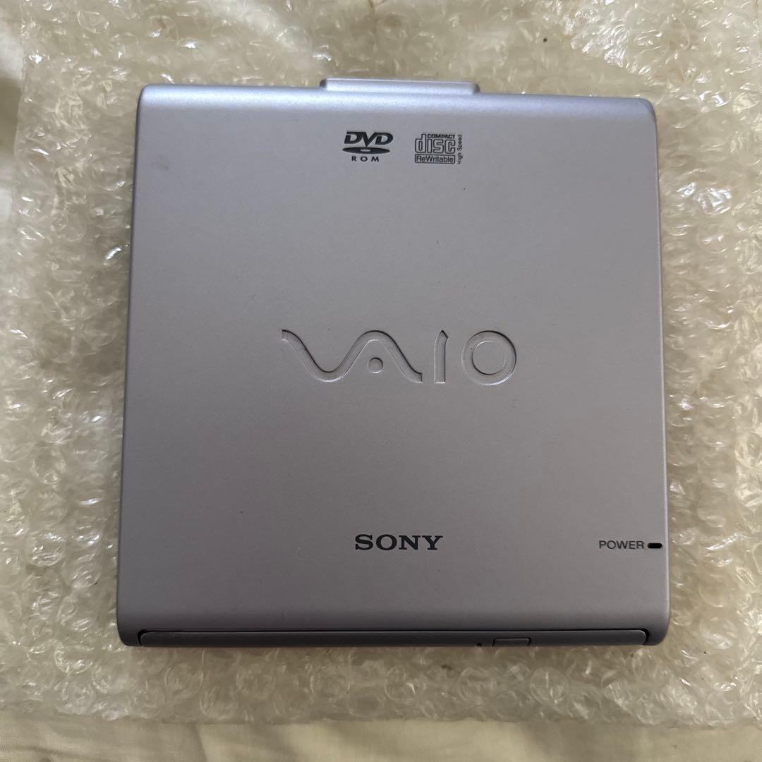 Top view of a silver Sony VAIO external DVD-ROM drive showing DVD and Sony logos and a power indicator.
