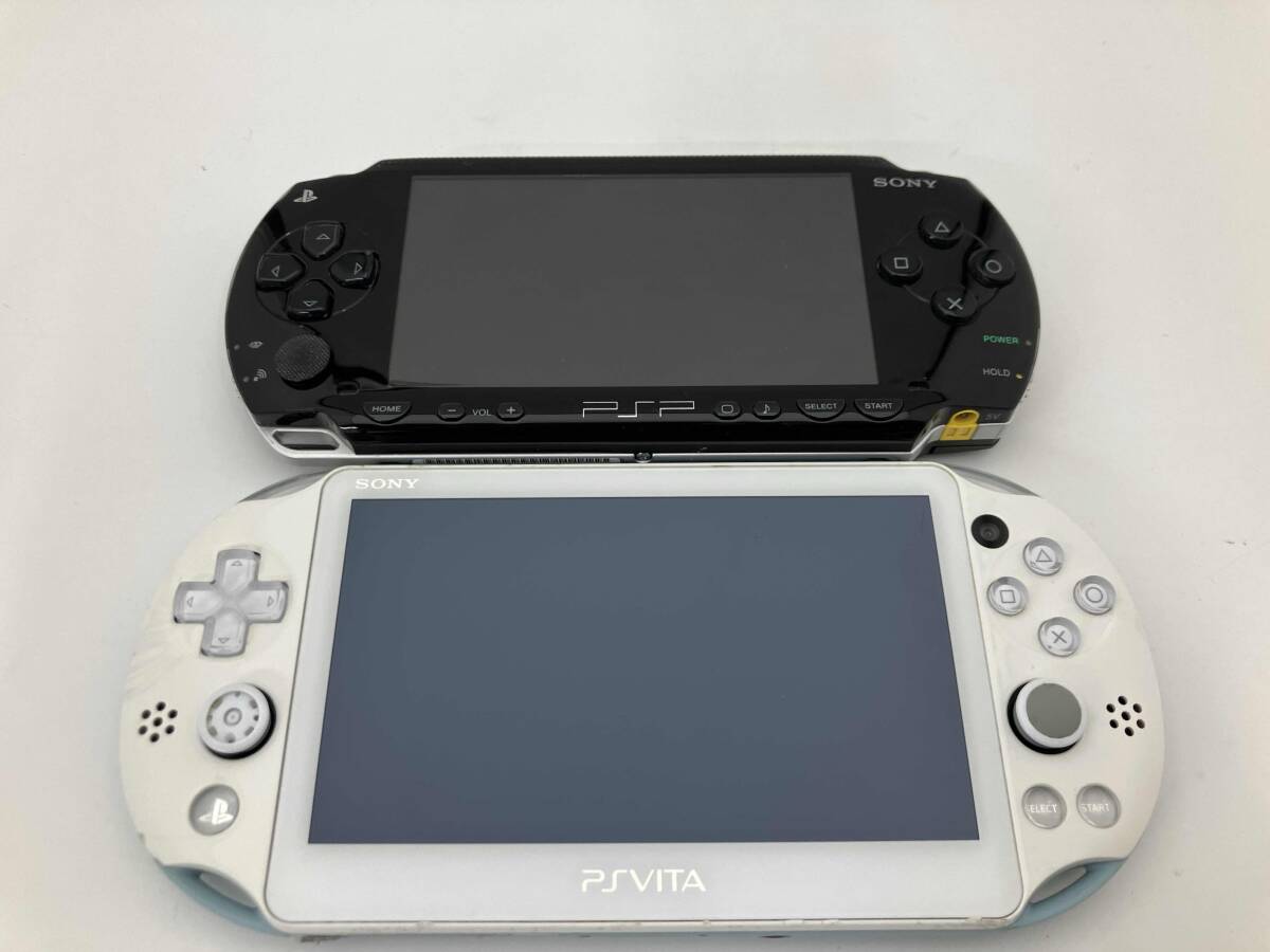 Front view of a black PSP-1000 and a white PlayStation Vita (PCH-2000) shown side by side.