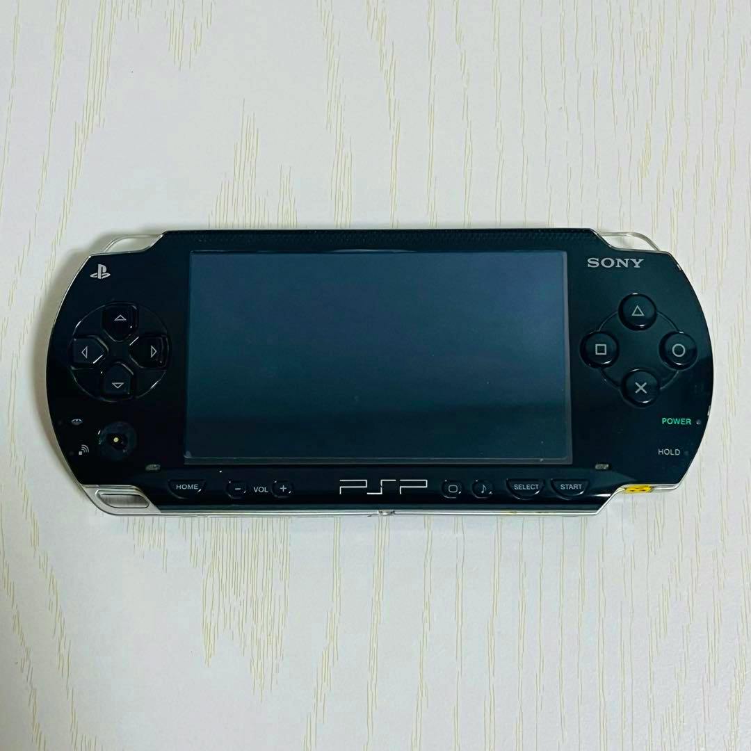 Top-down front view of the black SONY PSP1000 handheld game console showing the screen and front controls.