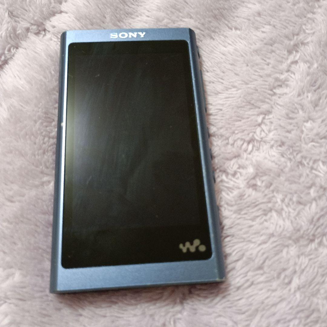 Front view of the moonlit-blue Sony Walkman NW-A55 portable digital audio player on a textured cloth surface.