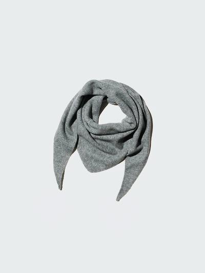 Gray triangular acrylic scarf arranged folded on a light background.