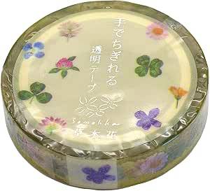 A roll of transparent decorative masking tape patterned with small pressed-flower and clover designs on the tape.