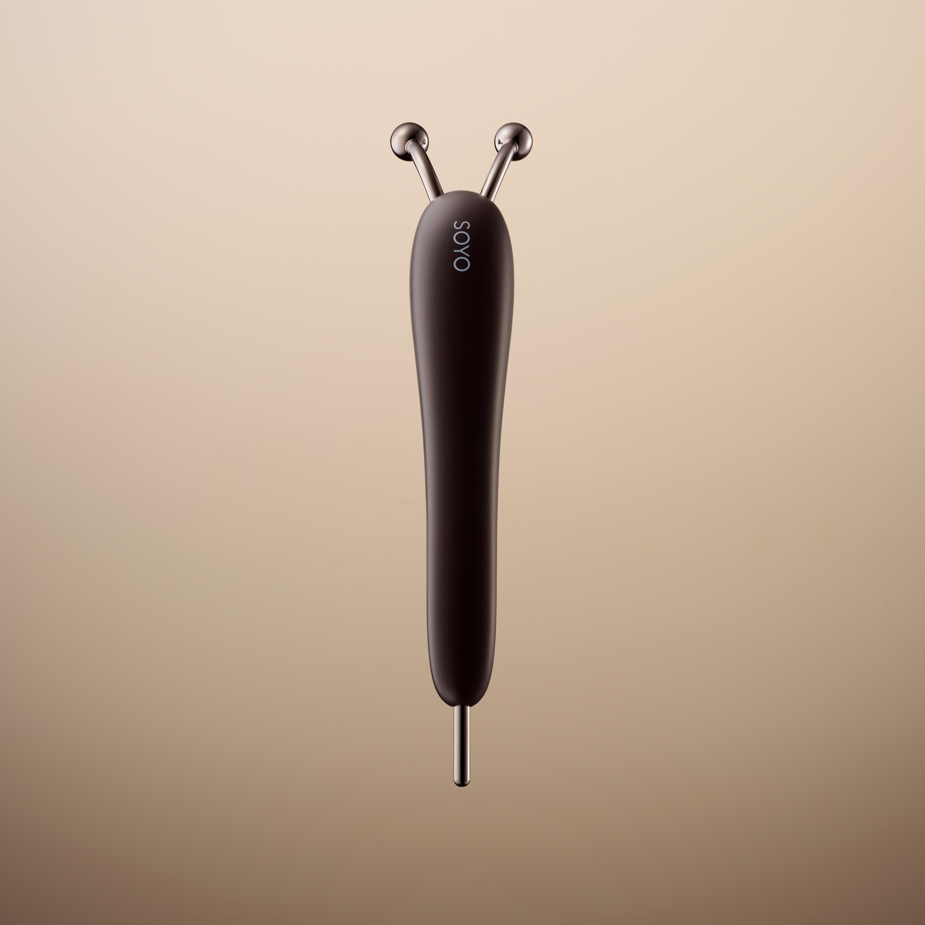 Front view of the SOYO facial massager showing its dual metal roller heads and elongated dark handle against a neutral background.