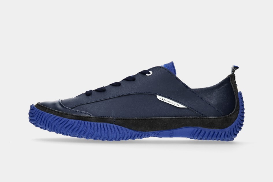 Side view of a navy and blue sports shoe on a plain light background.
