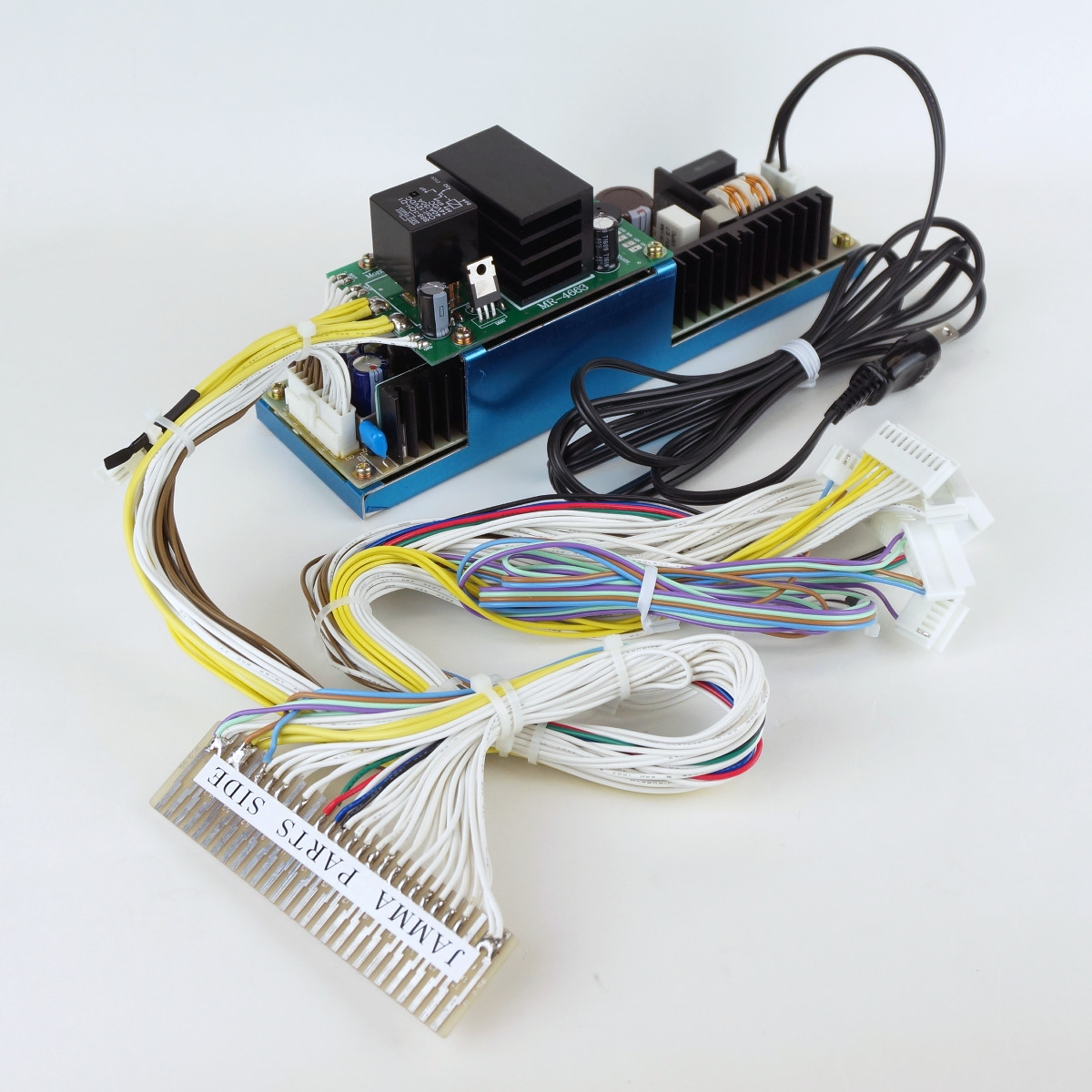 JAMMA conversion harness kit showing a circuit board with heatsinks, attached cables, and a JAMMA connector.