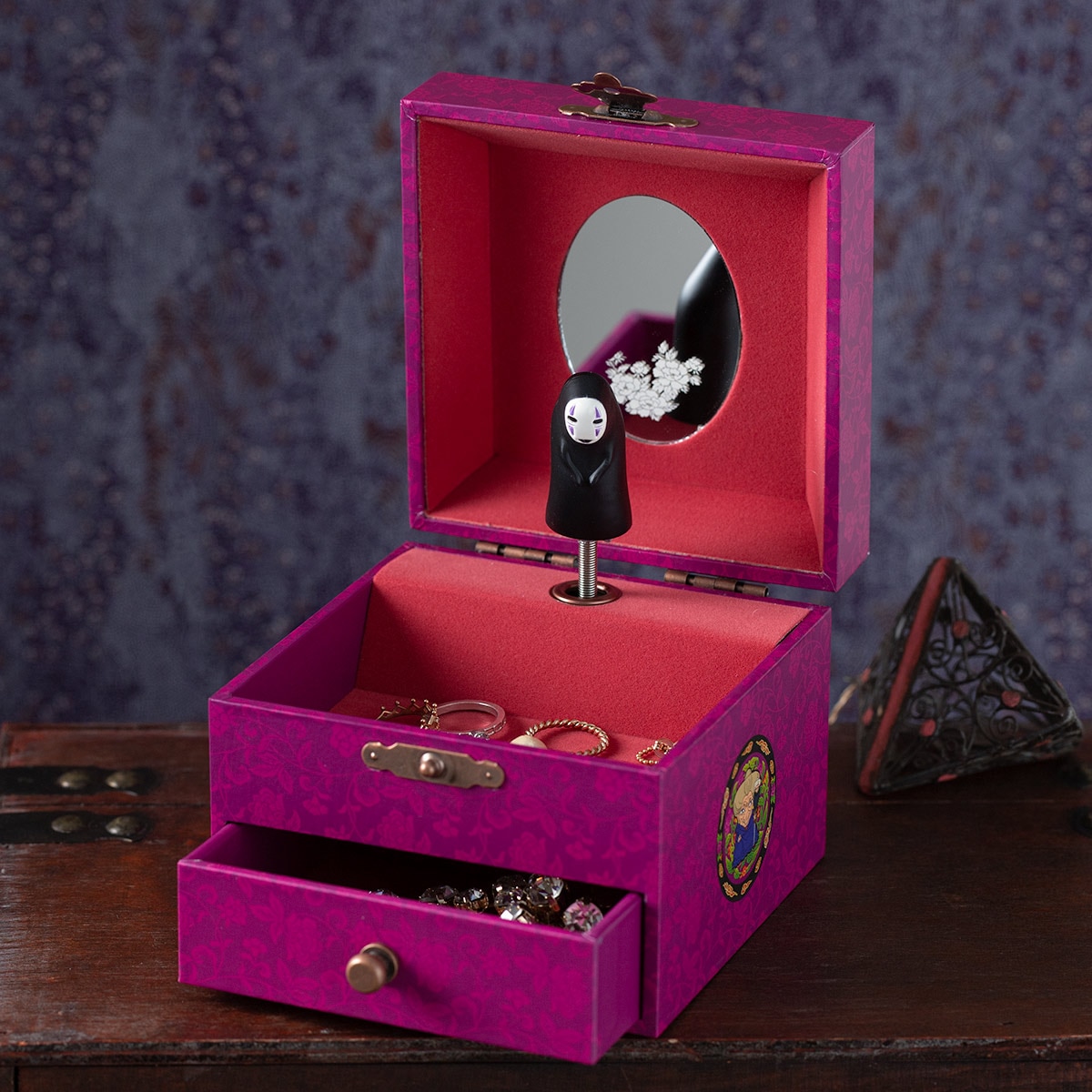 Open paper music box (Spirited Away) with a No-Face figurine on the spindle, interior mirror, and a small front drawer visible.