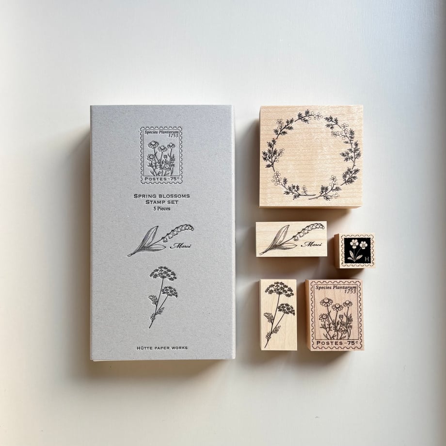 Flat-lay photo of the Spring Blossoms wooden stamp set showing the box and five wooden stamps on a light background.