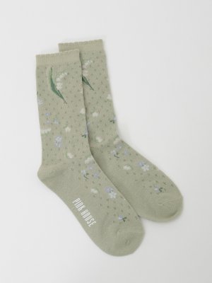 Light green women's cotton socks with a scattered posy floral pattern and "PINK HOUSE" printed on the sole, laid flat on a white background.
