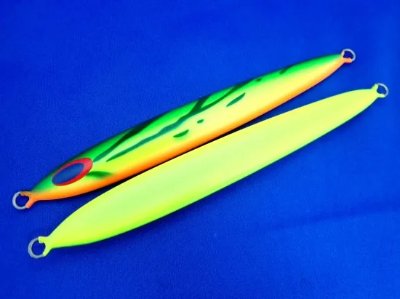 Two high-visibility fishing jigs/lures with yellow and green finish shown on a blue background.