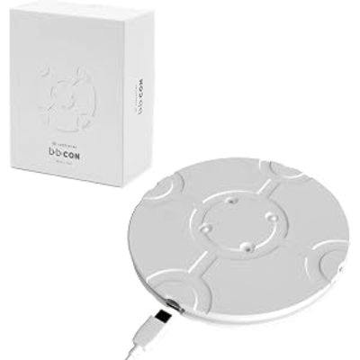 A round disc-shaped bb-con video game controller with an attached USB cable shown next to its white product box.