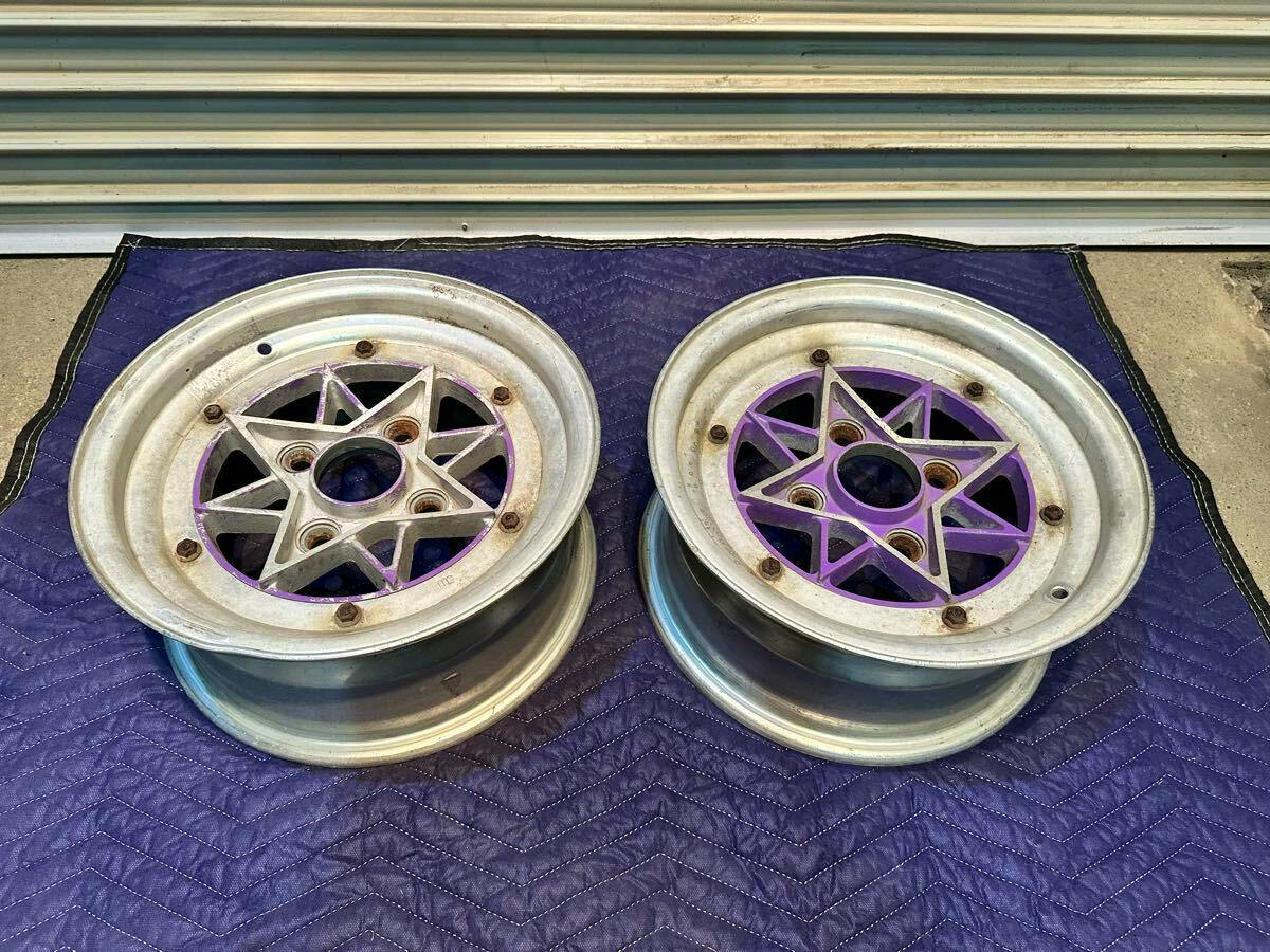 Two SSR 13-inch car wheels with star-shaped centers placed side by side on a padded mat.
