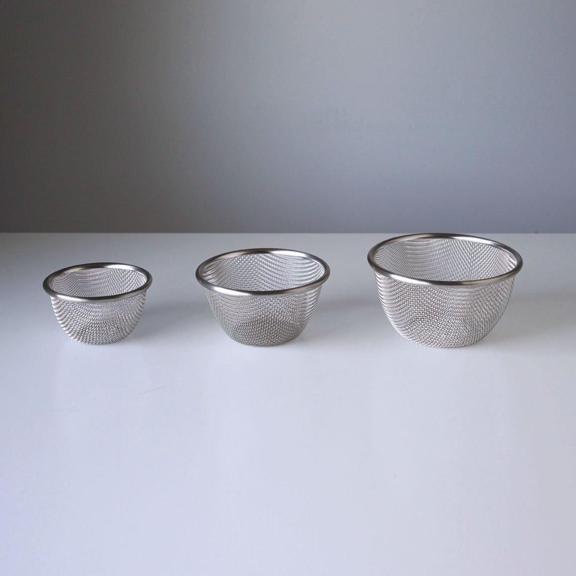 Three stainless steel mesh noodle strainers in small, medium, and large sizes arranged side by side on a white surface.