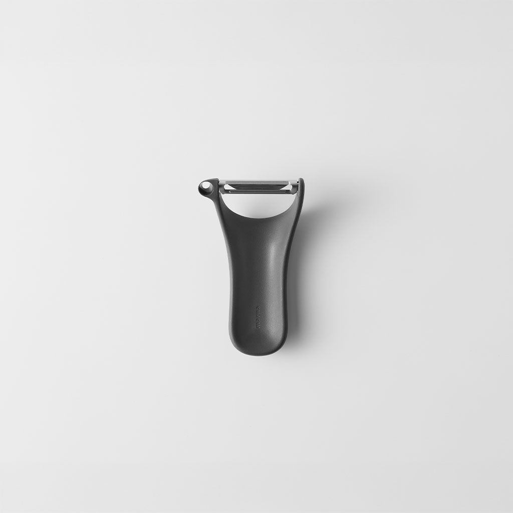 Top-down photo of a stainless steel peeler with a dark handle centered on a white background.