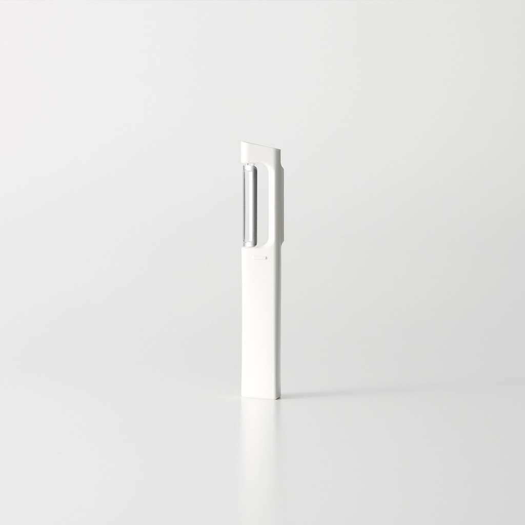 A white standing peeler with a visible stainless-steel blade on a white background.