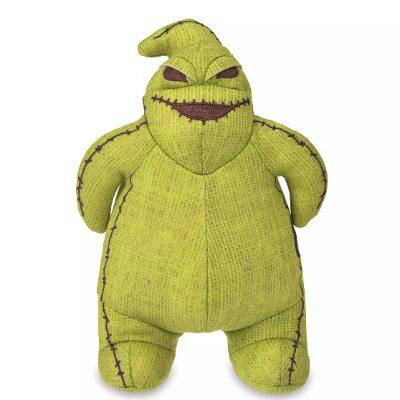 Green StanDS Oogie plush toy standing upright with stitched eyes, mouth, and seams visible.