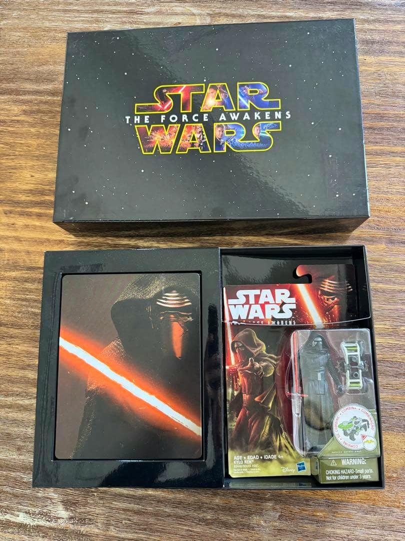 Opened Star Wars: The Force Awakens MovieNEX premium box showing the outer box, a Kylo Ren steelbook insert, and a packaged Kylo Ren figure.