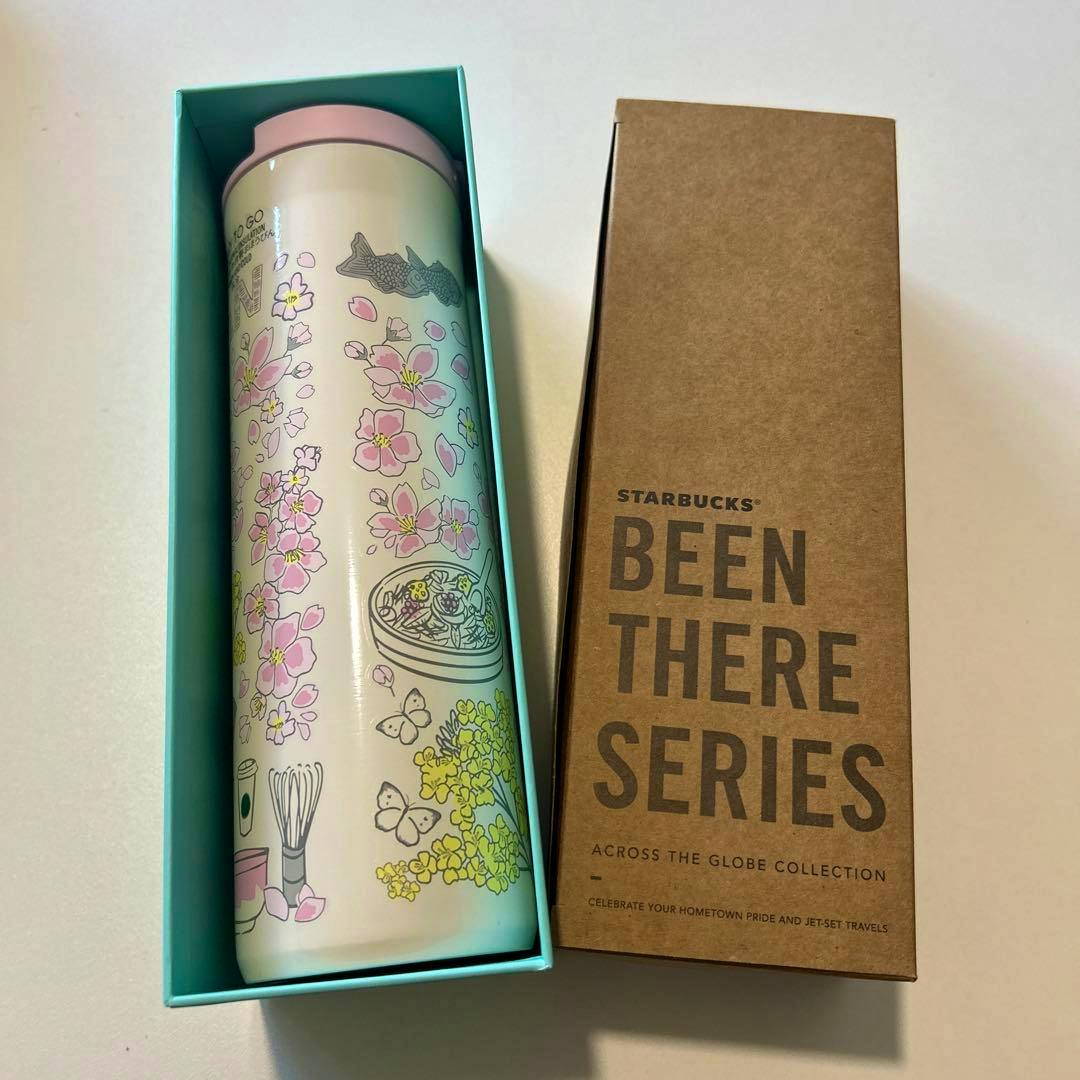 Starbucks Been There Series tumbler with pink lid and floral illustrations shown inside a teal presentation box next to its Been There Series cardboard sleeve.