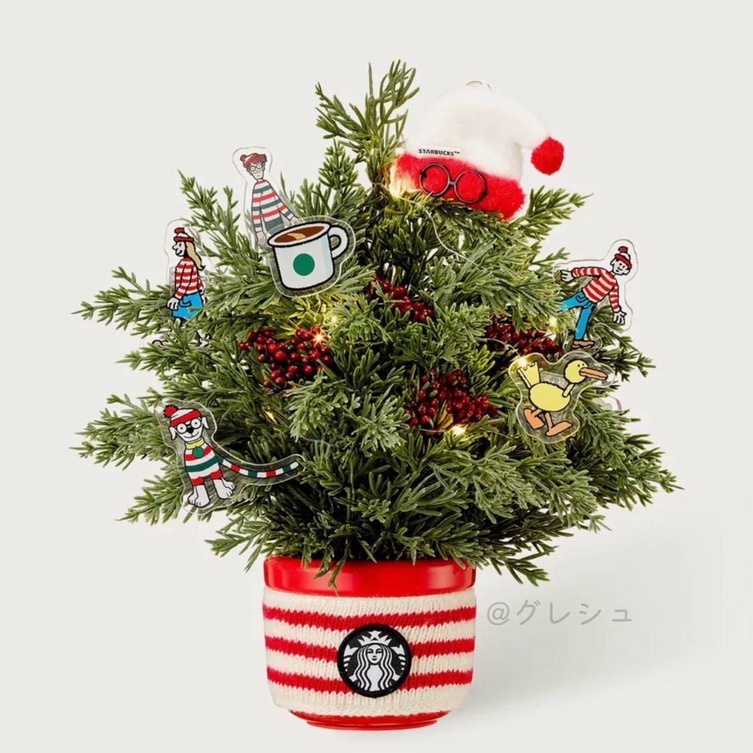 Plastic potted tabletop Christmas tree with Wally-themed ornaments and a red-and-white striped Starbucks pot cover.