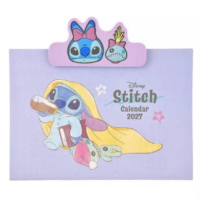 Front cover of the Stitch & Scrump 2027 wall calendar with a decorative clip depicting Stitch and Scrump on a lavender background.