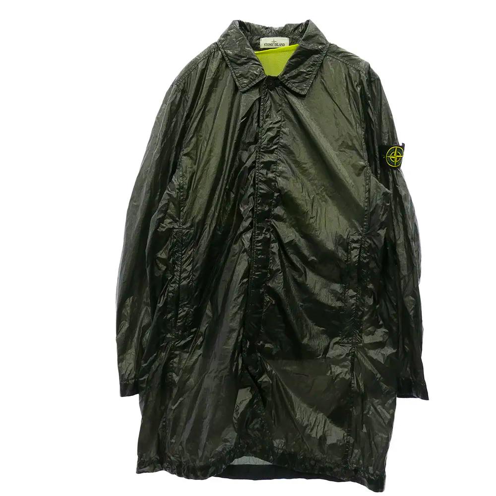 Front view of a dark Stone Island packable trench coat showing the full coat and sleeve badge.