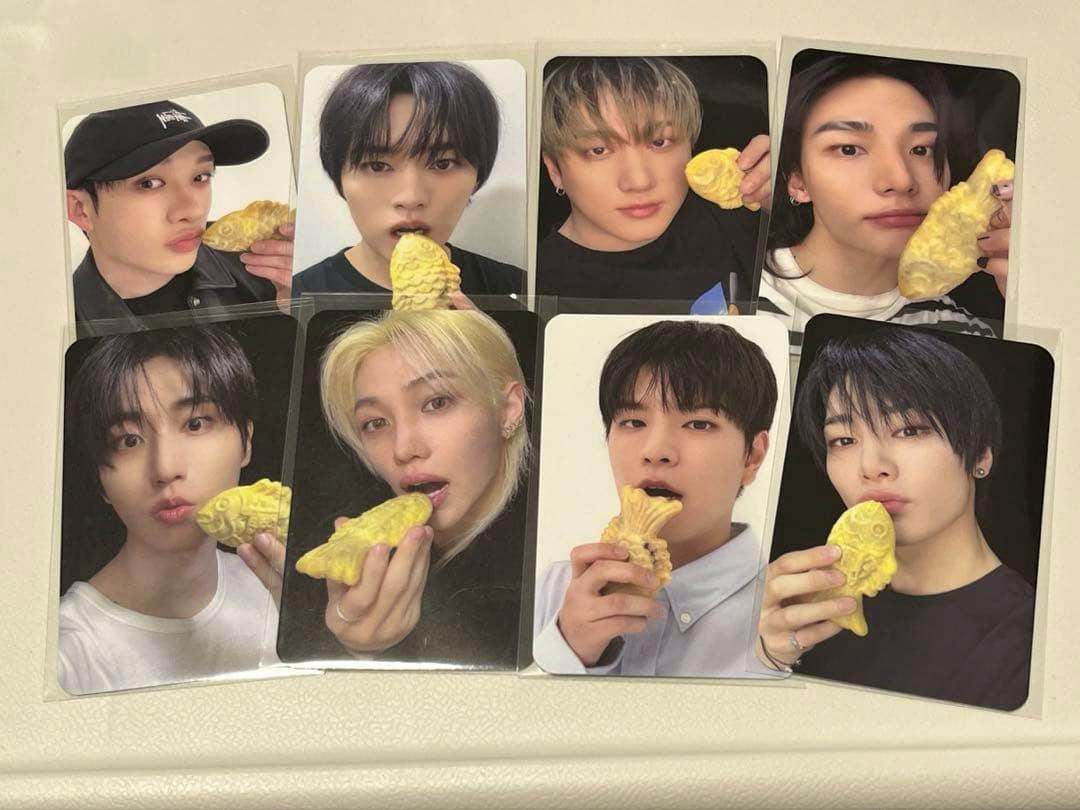 Nine photocard images laid out showing people holding yellow taiyaki-shaped snacks.
