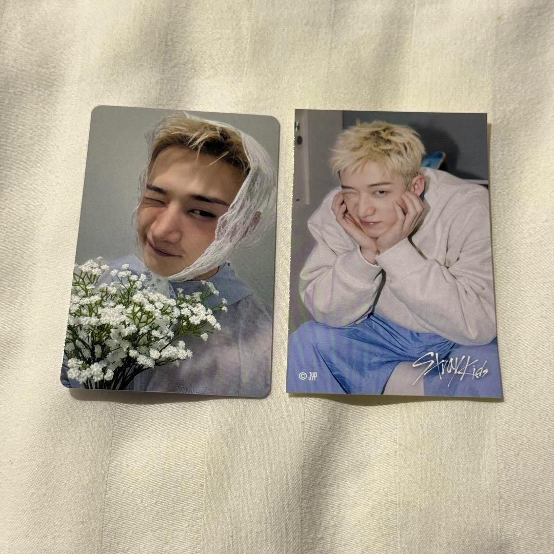 Two StrayKids photocard images from the Bangchan SUIATSU set placed on a light fabric background.