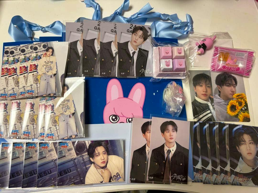 Multiple Stray Kids photocards featuring Changbin and small related fan goods arranged on a table.