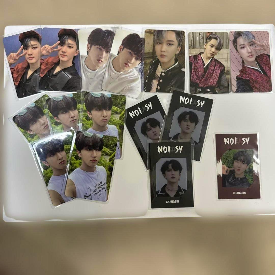 A set of Stray Kids Changbin photocards (16-piece set) arranged on a white surface showing various front and back card designs.