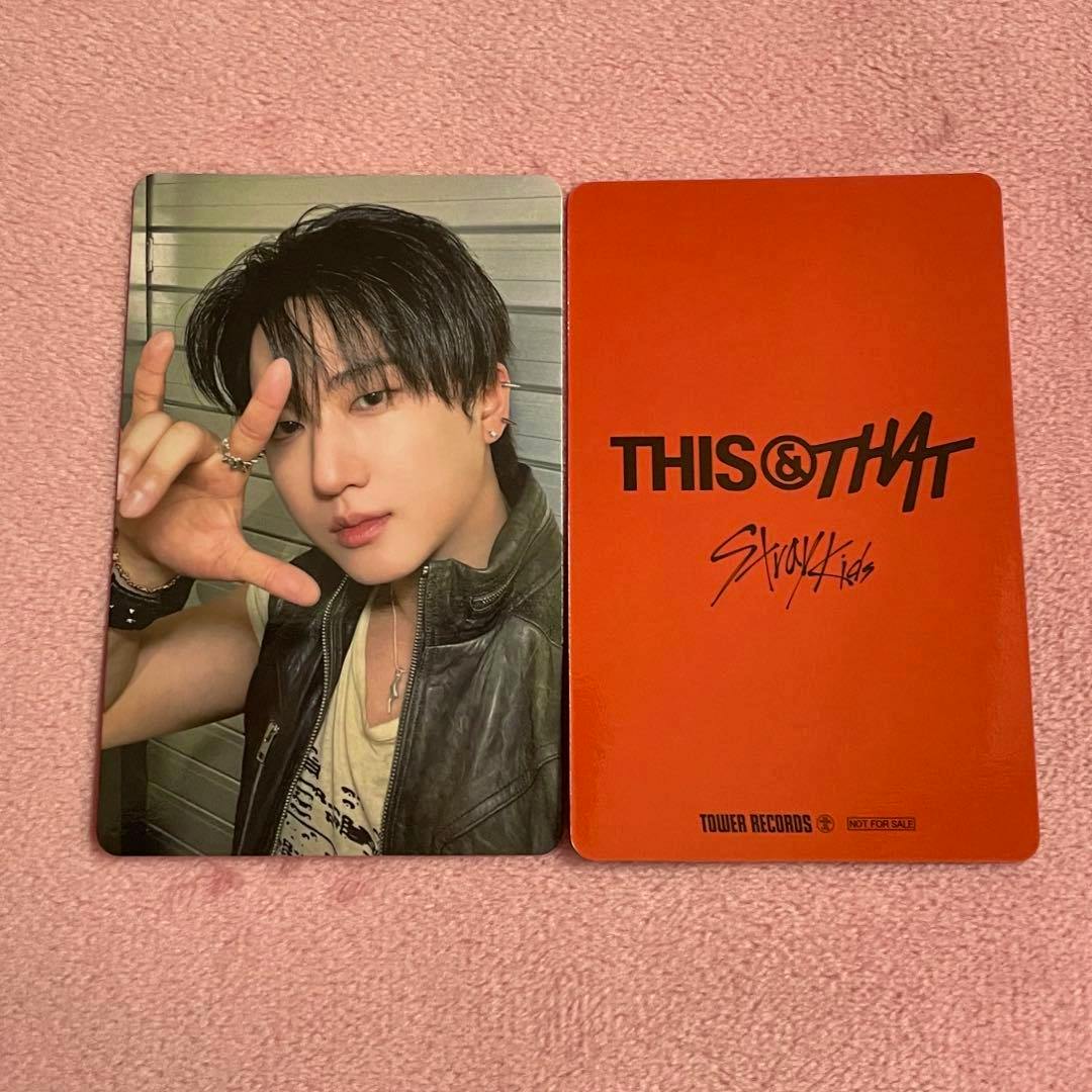 A Stray Kids THIS＆THAT Tower Records photocard showing a member portrait on the left and the orange THIS＆THAT back design on the right.