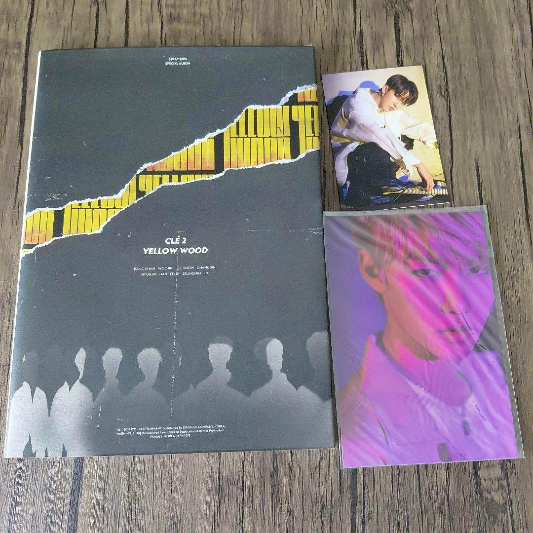 Stray Kids CLÉ 2: YELLOW WOOD album sleeve displayed with two photo cards on a wood surface.