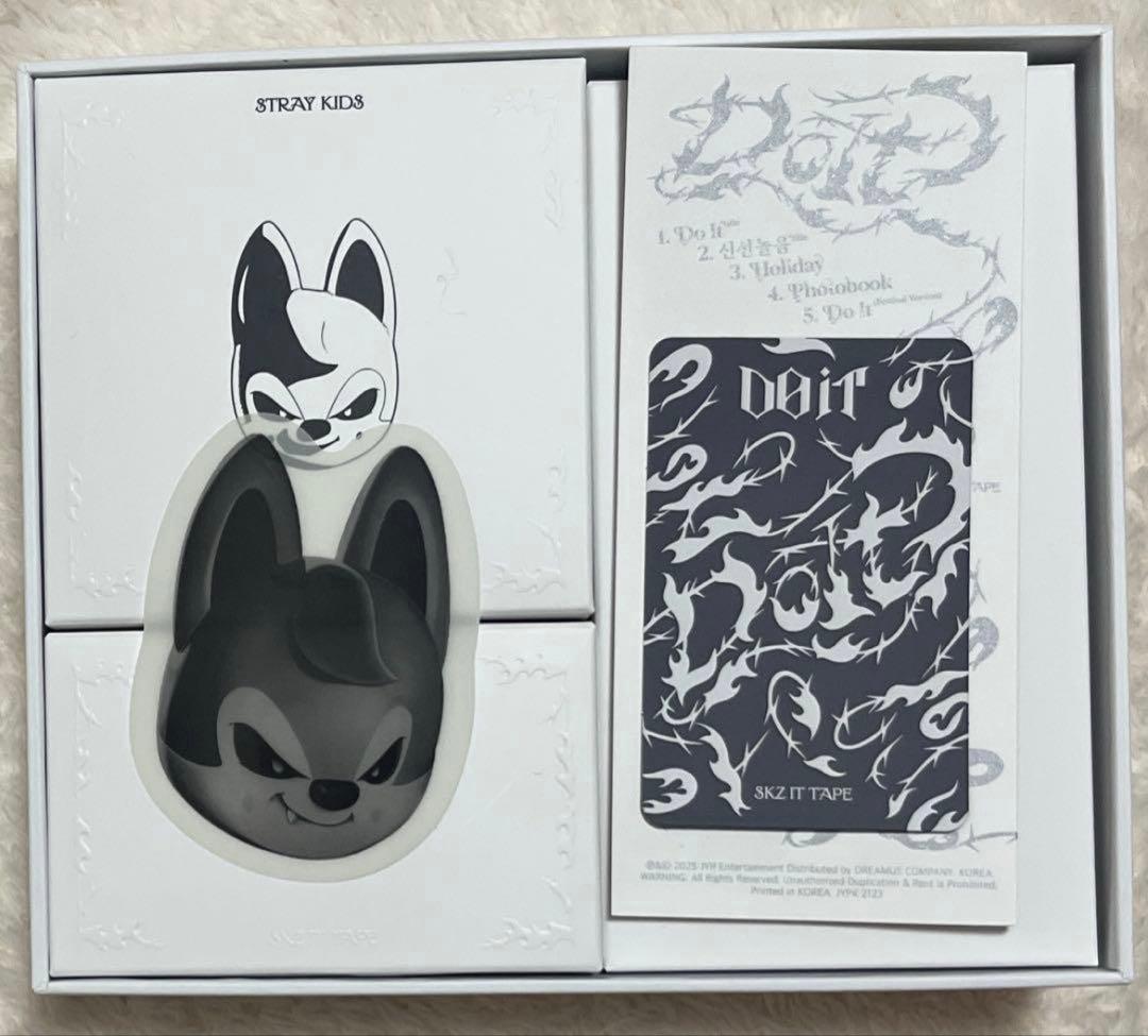 Boxed Stray Kids EVIL SKZOO package showing the wolf-character Bluetooth speaker visible through a window and accompanying printed inserts.