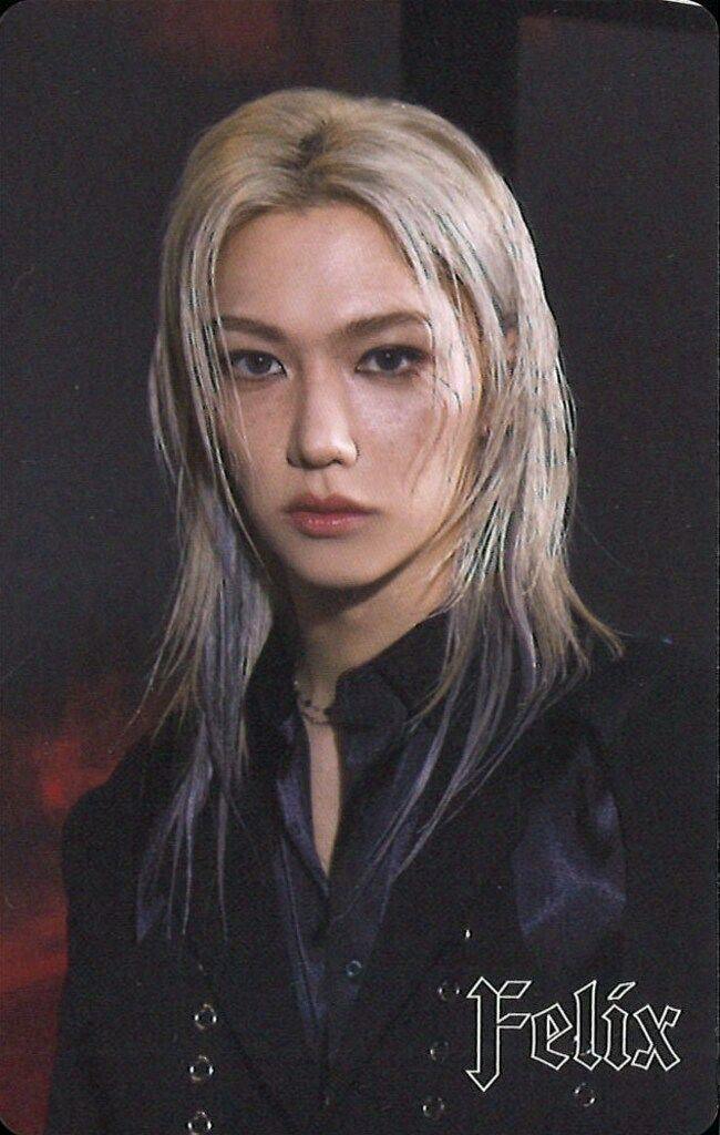 Photocard portrait of a person with blond hair wearing a black outfit, with the word "Felix" printed in the corner.