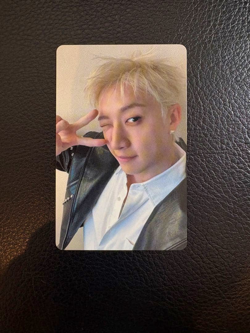 Front of the Stray Kids photocard showing a member winking and making a peace sign.