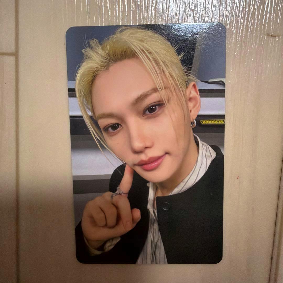 Front side of the photocard showing a close-up portrait of Felix from Stray Kids RUN IT JAPAN with blond hair and his finger touching his cheek.