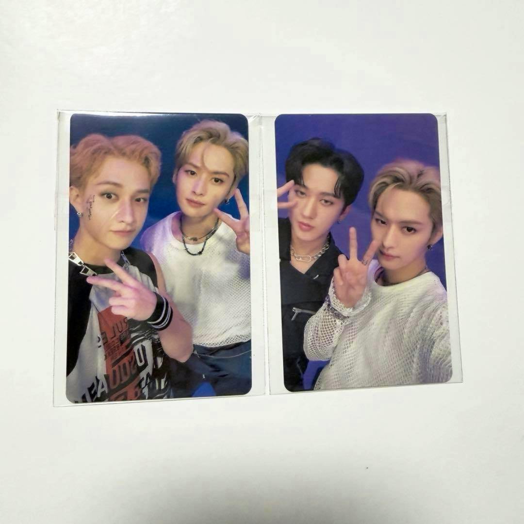 Two Stray Kids unit photocards in plastic sleeves showing members posing with peace signs on a white background.