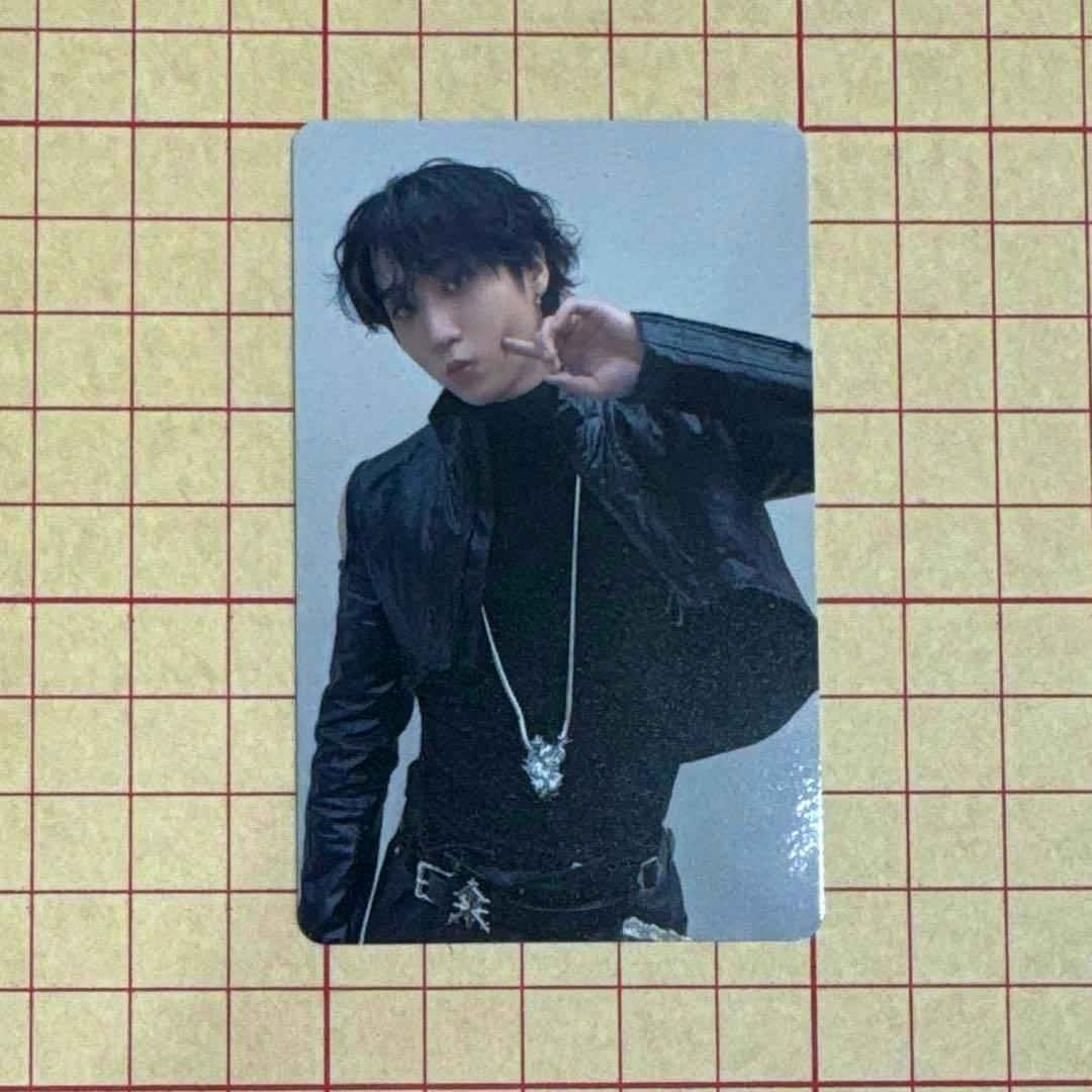 Photocard of HAN (StrayKids) from THIS&THAT showing him in a black outfit and necklace posing with his hand near his face.