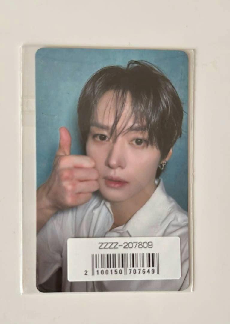 Front of a photocard showing a person giving a thumbs-up, with a barcode sticker covering the lower area.